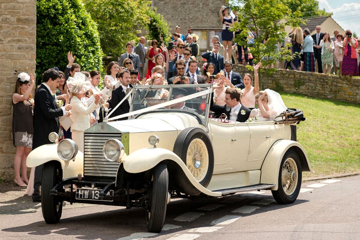 Bride and groom leaving All Saints church in Polebrook