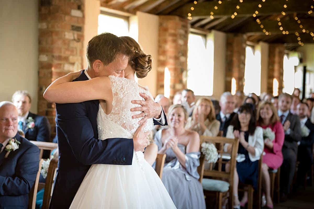 Bride & Groom hugging during wedding ceremony at Dodmoor House
