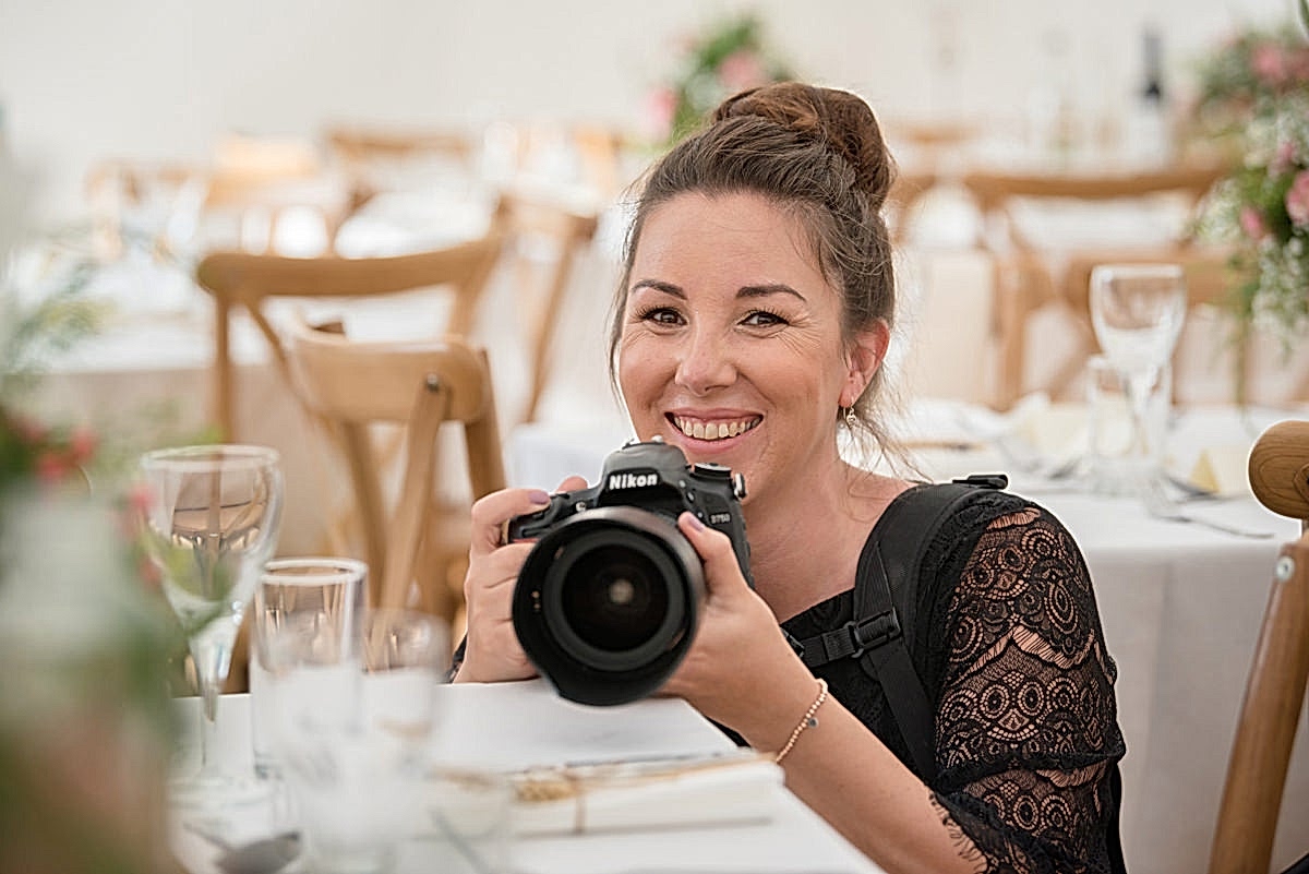 Sarah Vivienne photographing table decor at a marquee wedding