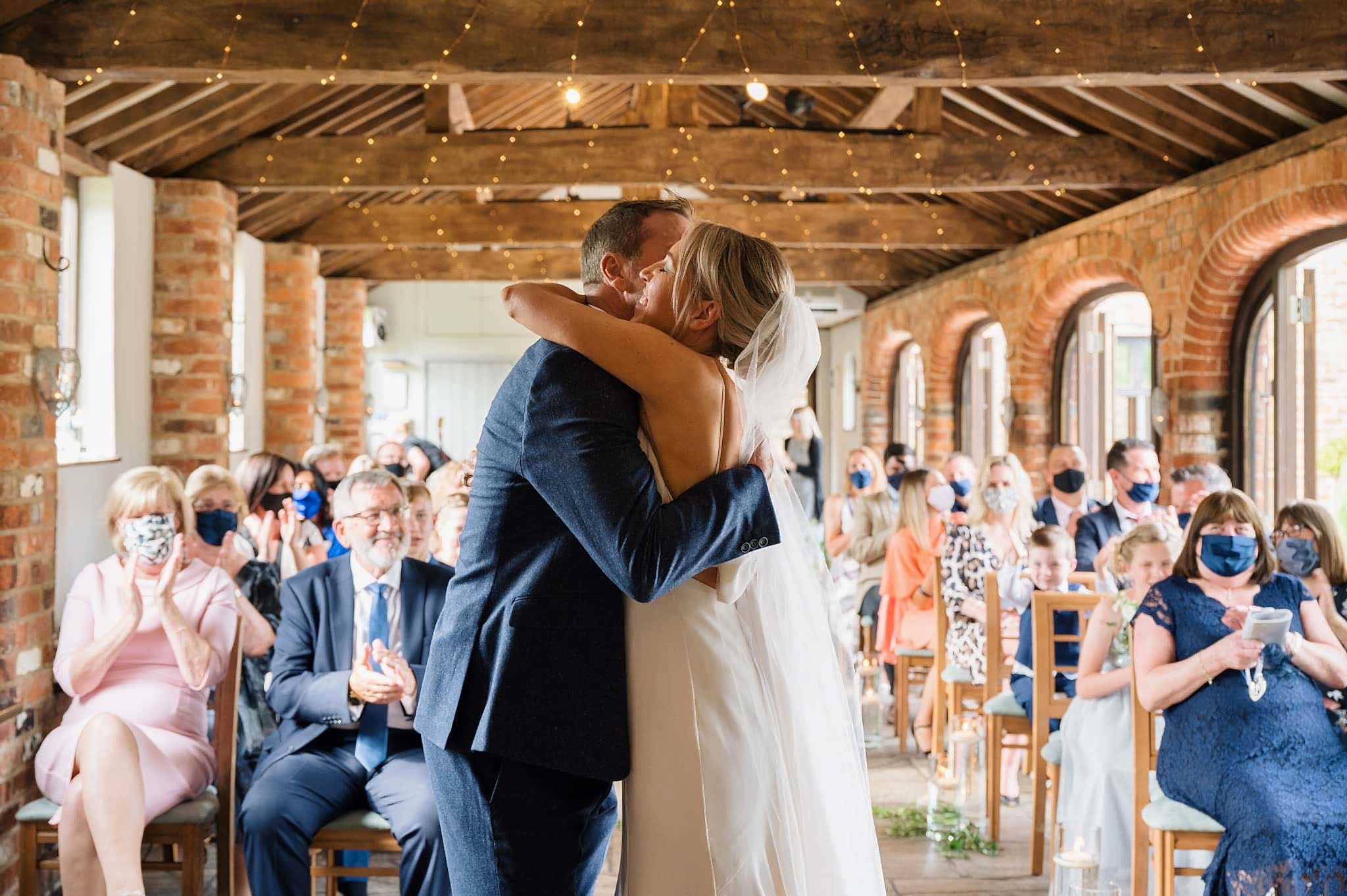 Couple hug at end of wedding ceremony at Dodmoor House