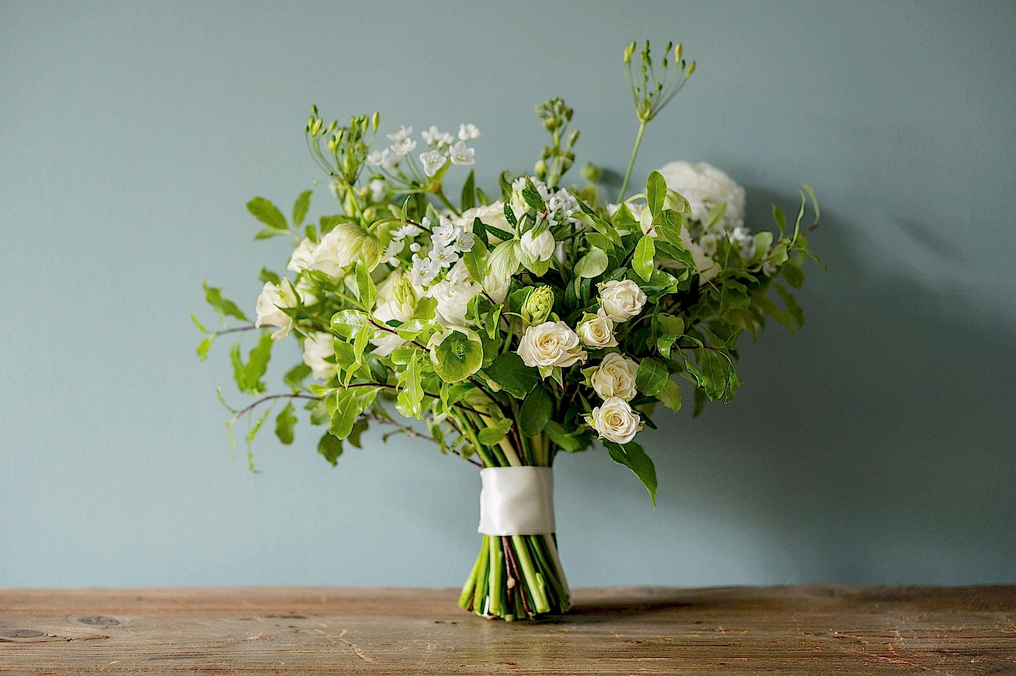 Bride's bouquet of fresh white and green spring flowers and foliage