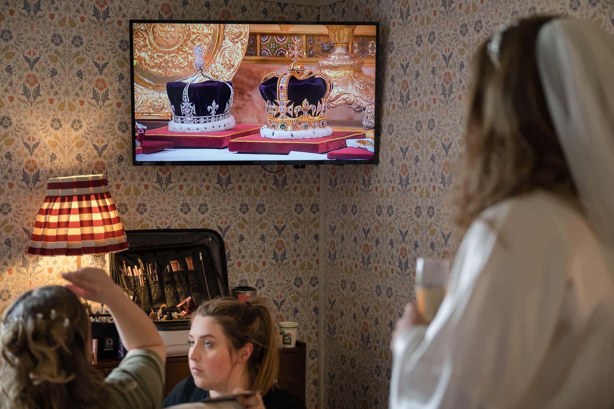 The bride looking at the King and Queen's crowns on TV on Coronation Day