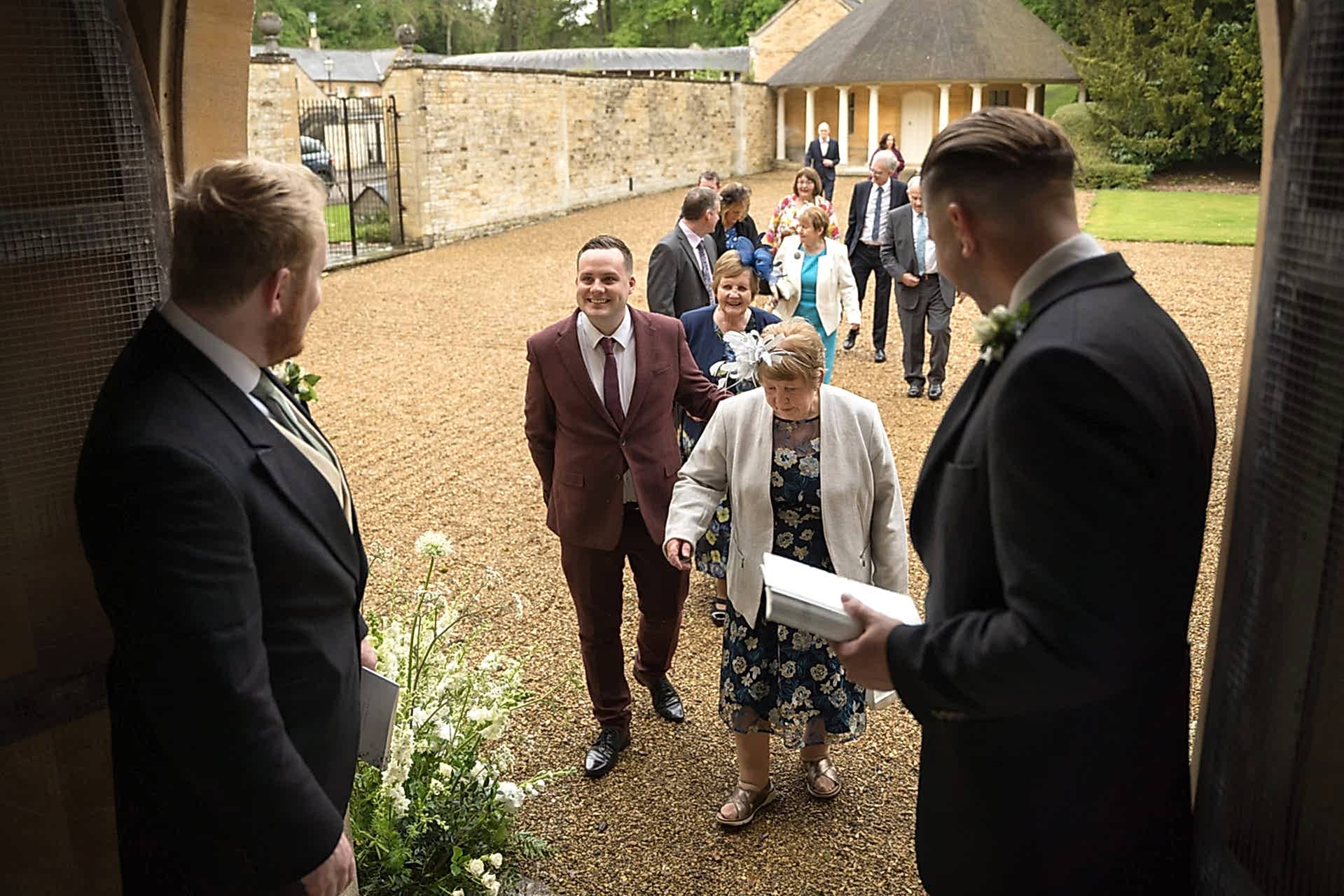 Ushers welcoming guests as they arrive at Exton Park chapel