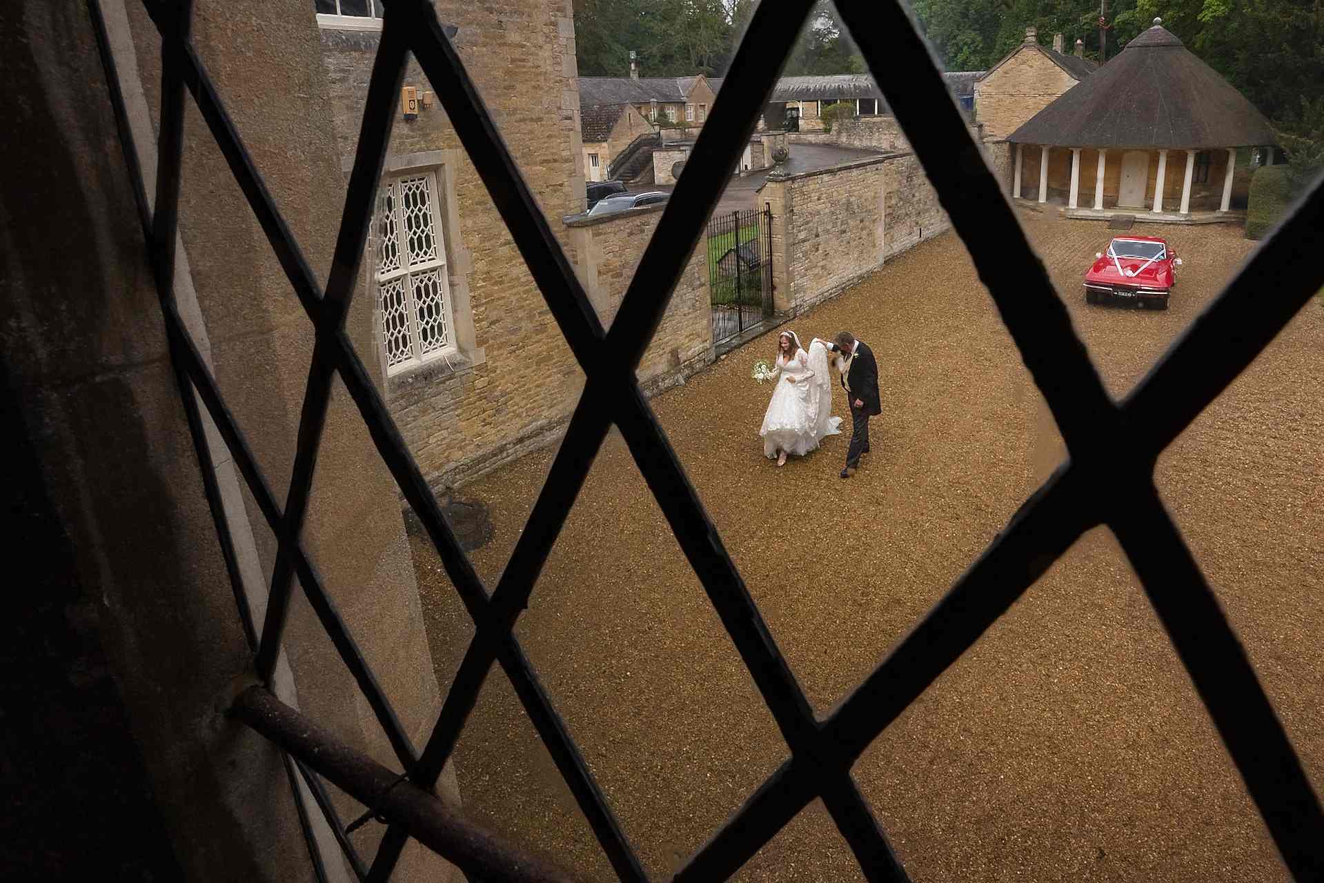 The bride and her Dad walking from the wedding car towards Exton Park chapel