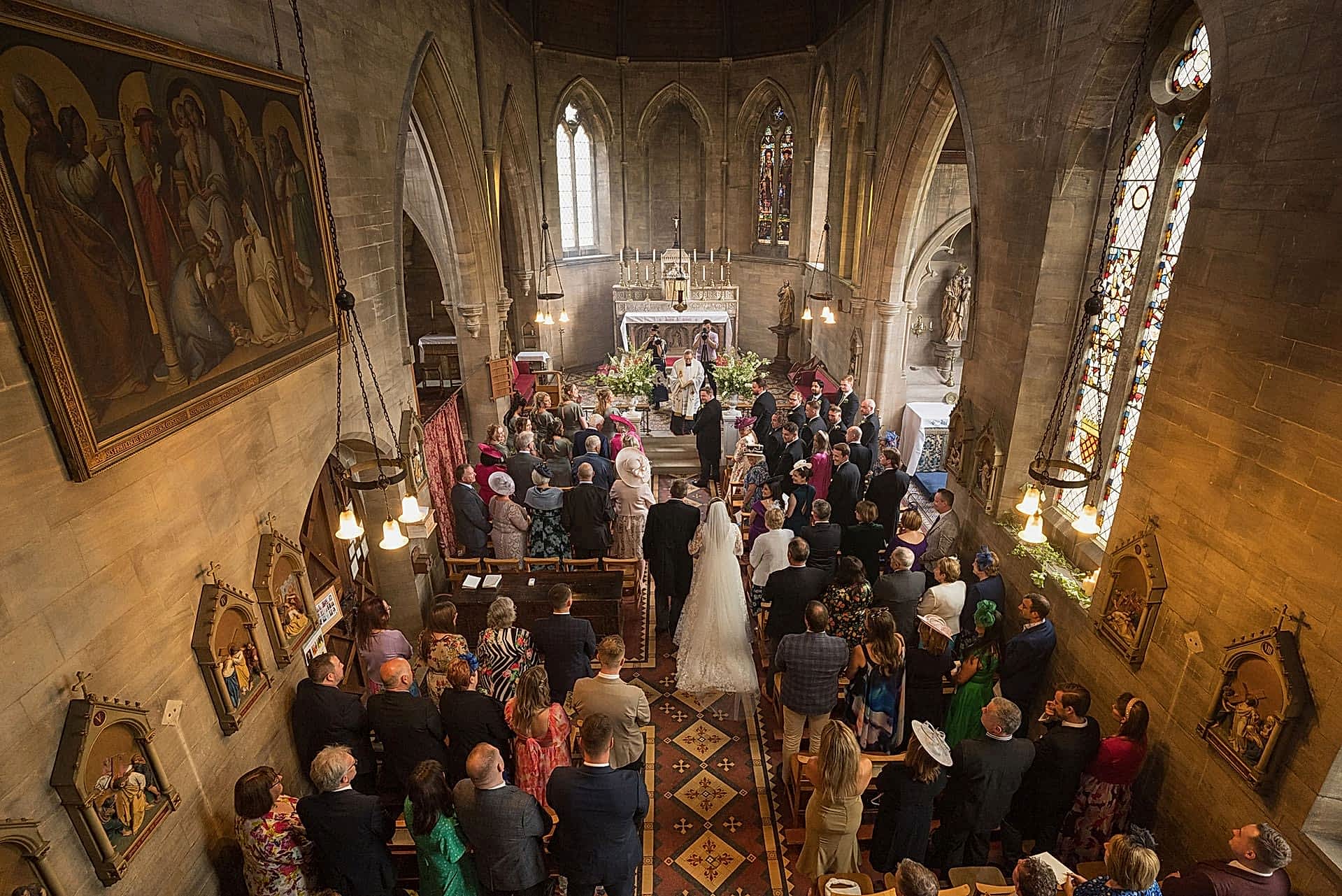 View from the balcony of the bride walking down the aisle at Exton Park chapel