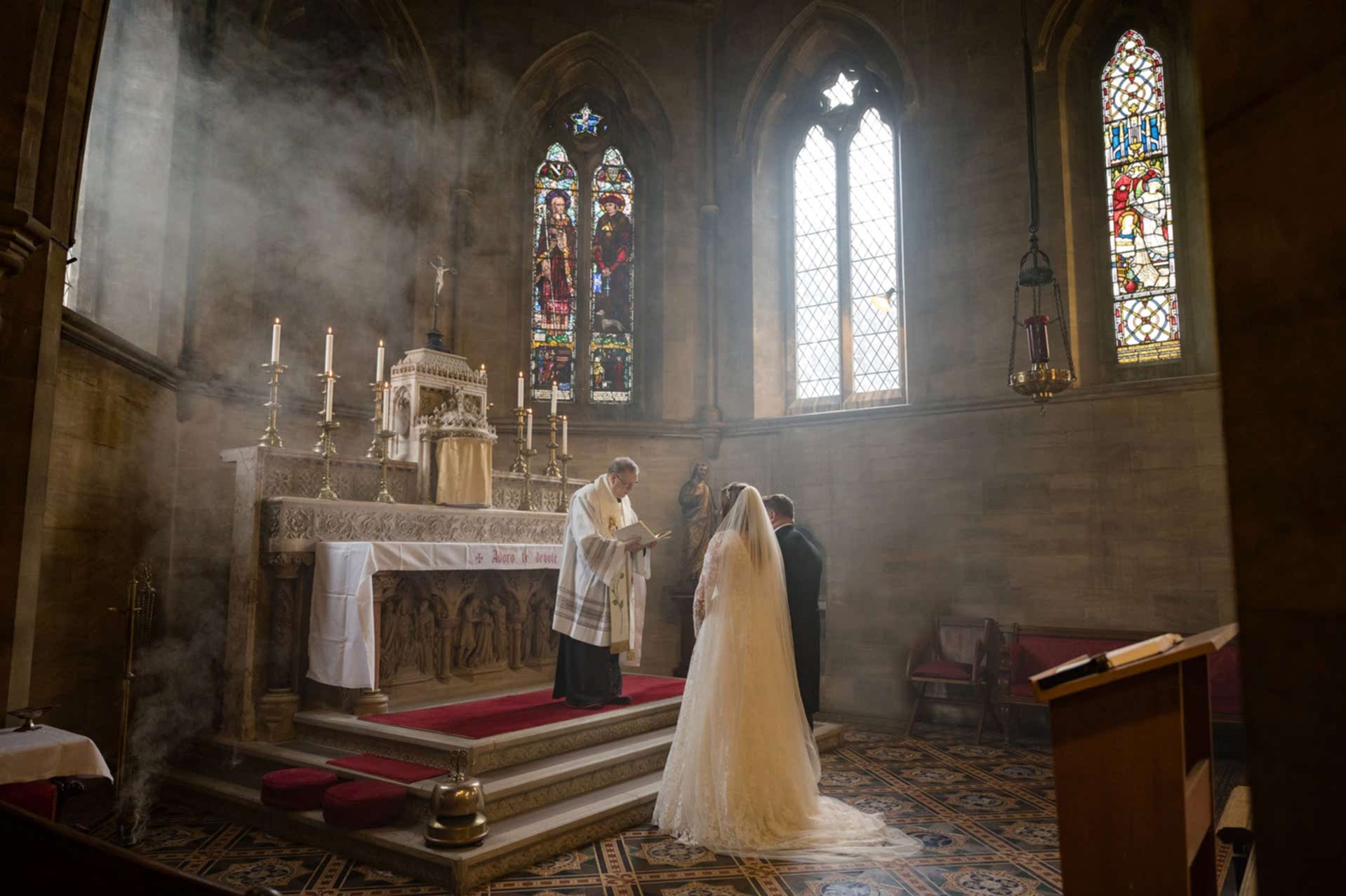 Bride and groom standing at the altar for prayers at the end of their marriage ceremony at Exton Park chapel