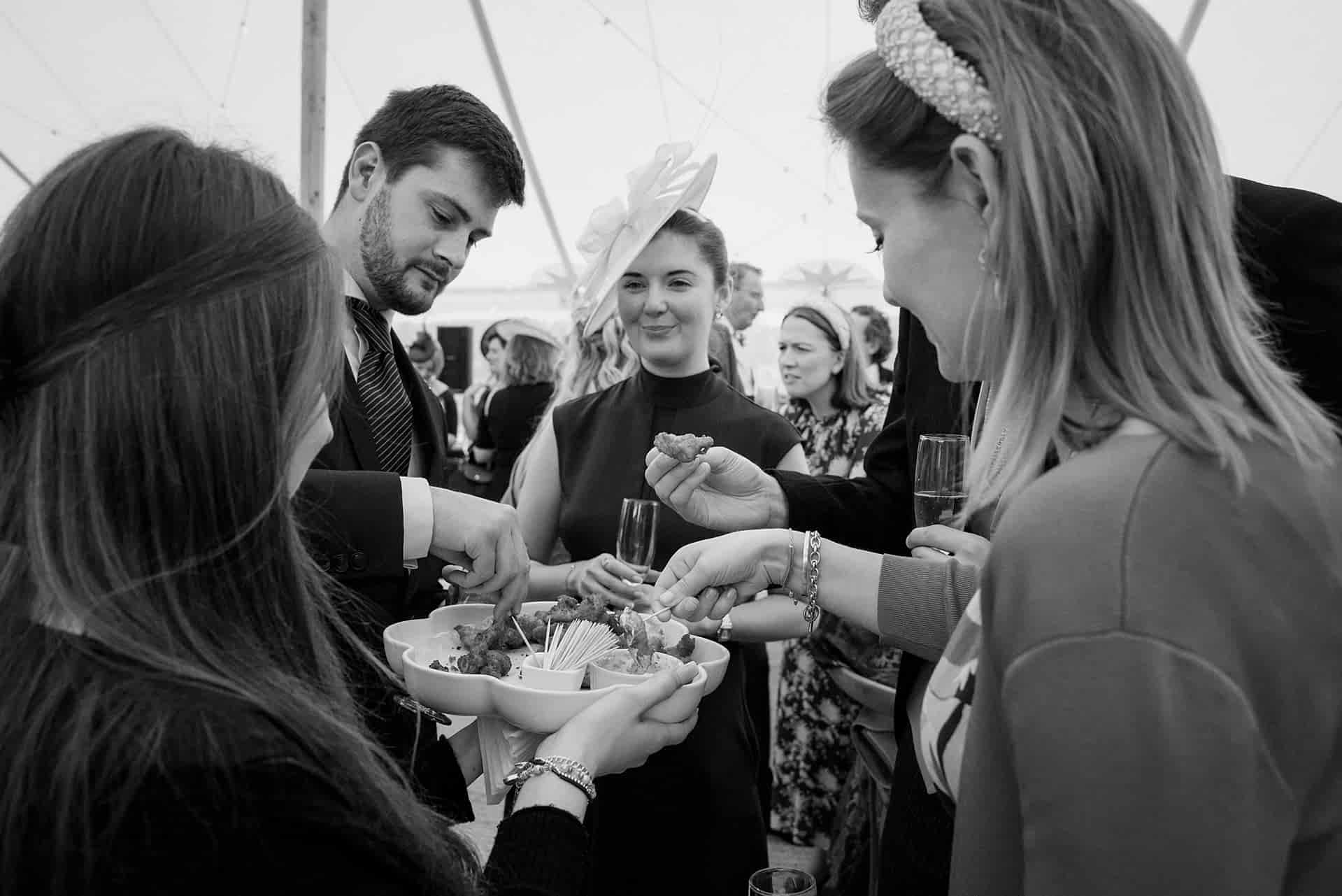 Wedding guests taking canapes