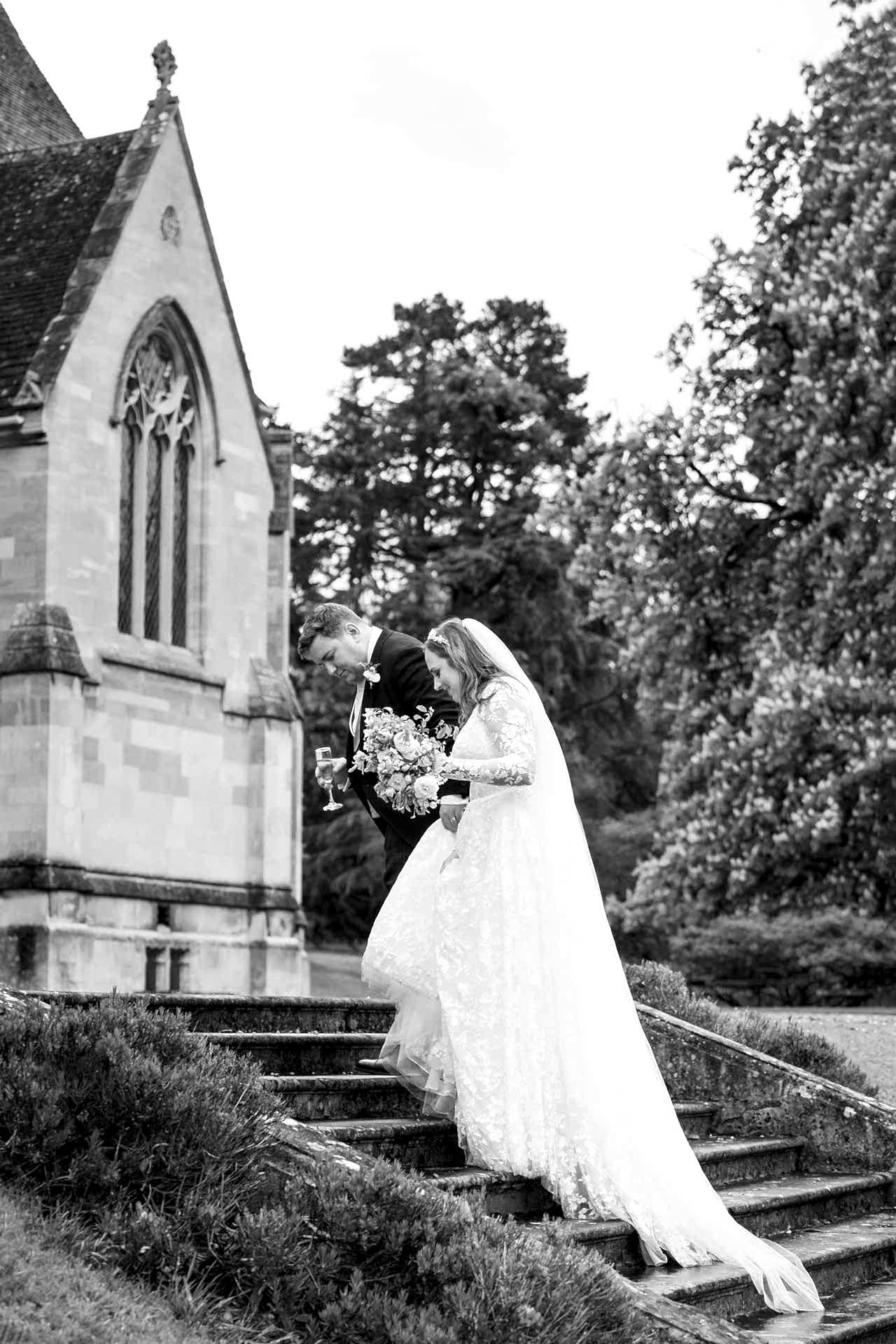 Bride and groom walking up steps outside Exton Park Hall