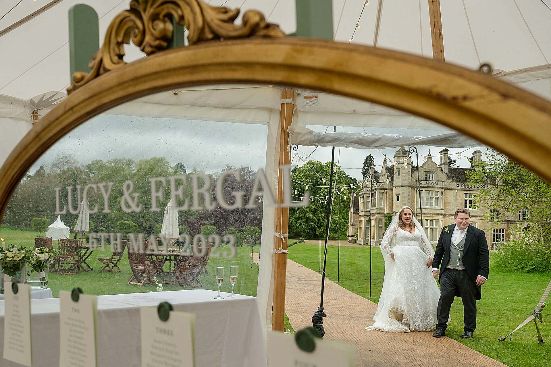 A reflection of the bride and groom and Exton Park hall in their mirrored table plan