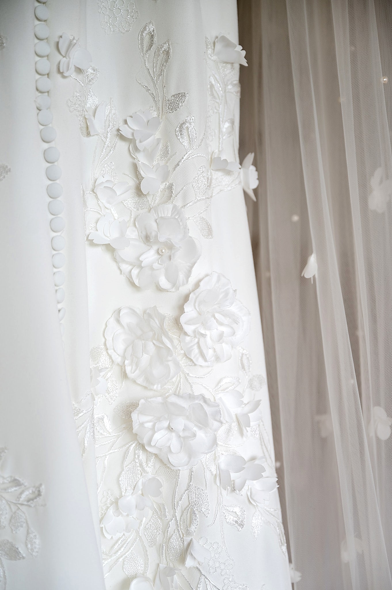 Close up detail of applique flowers on a Kelly Faetanini wedding dress