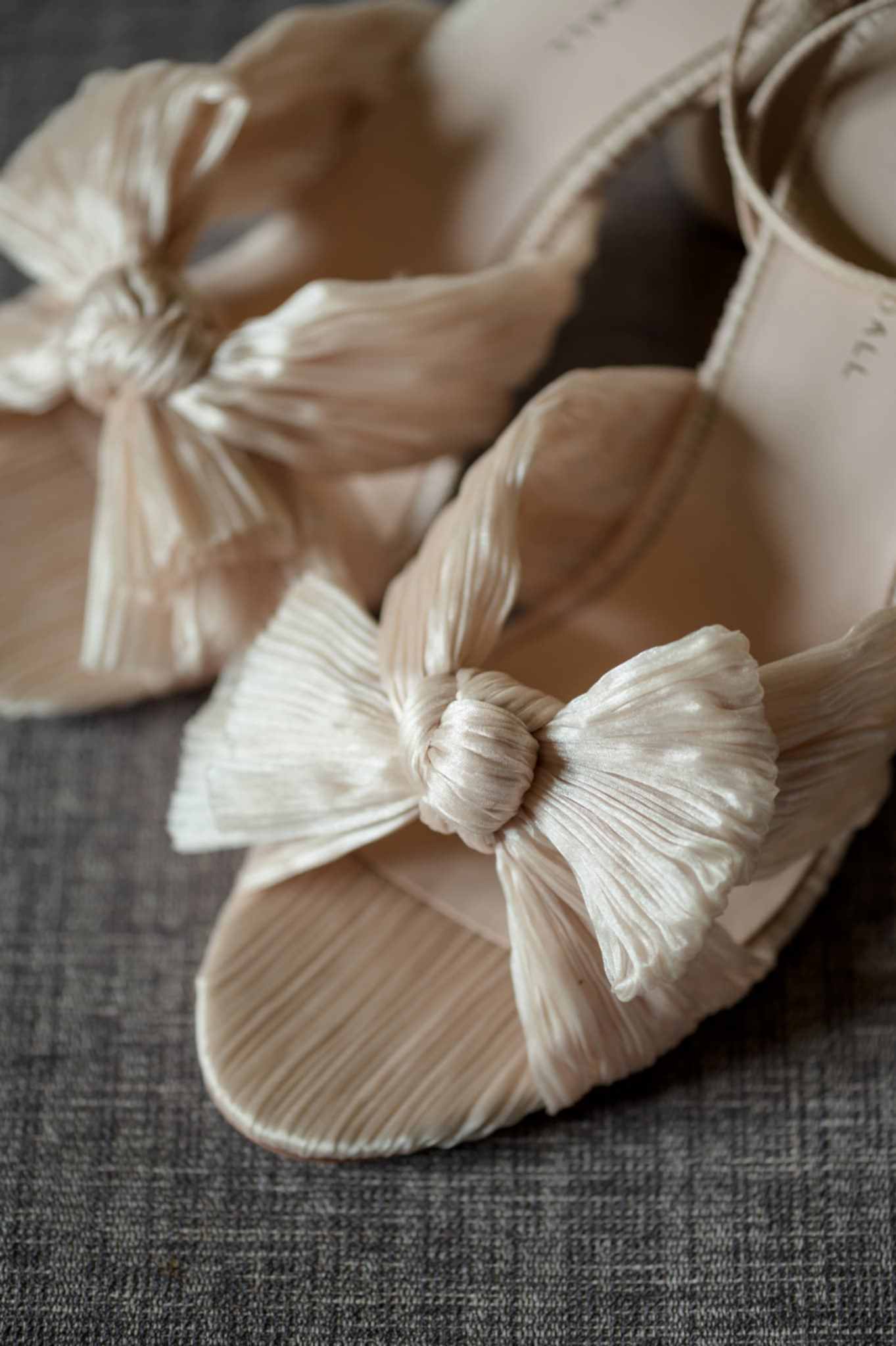 Close up detail of a bow on a pair of wedding shoes