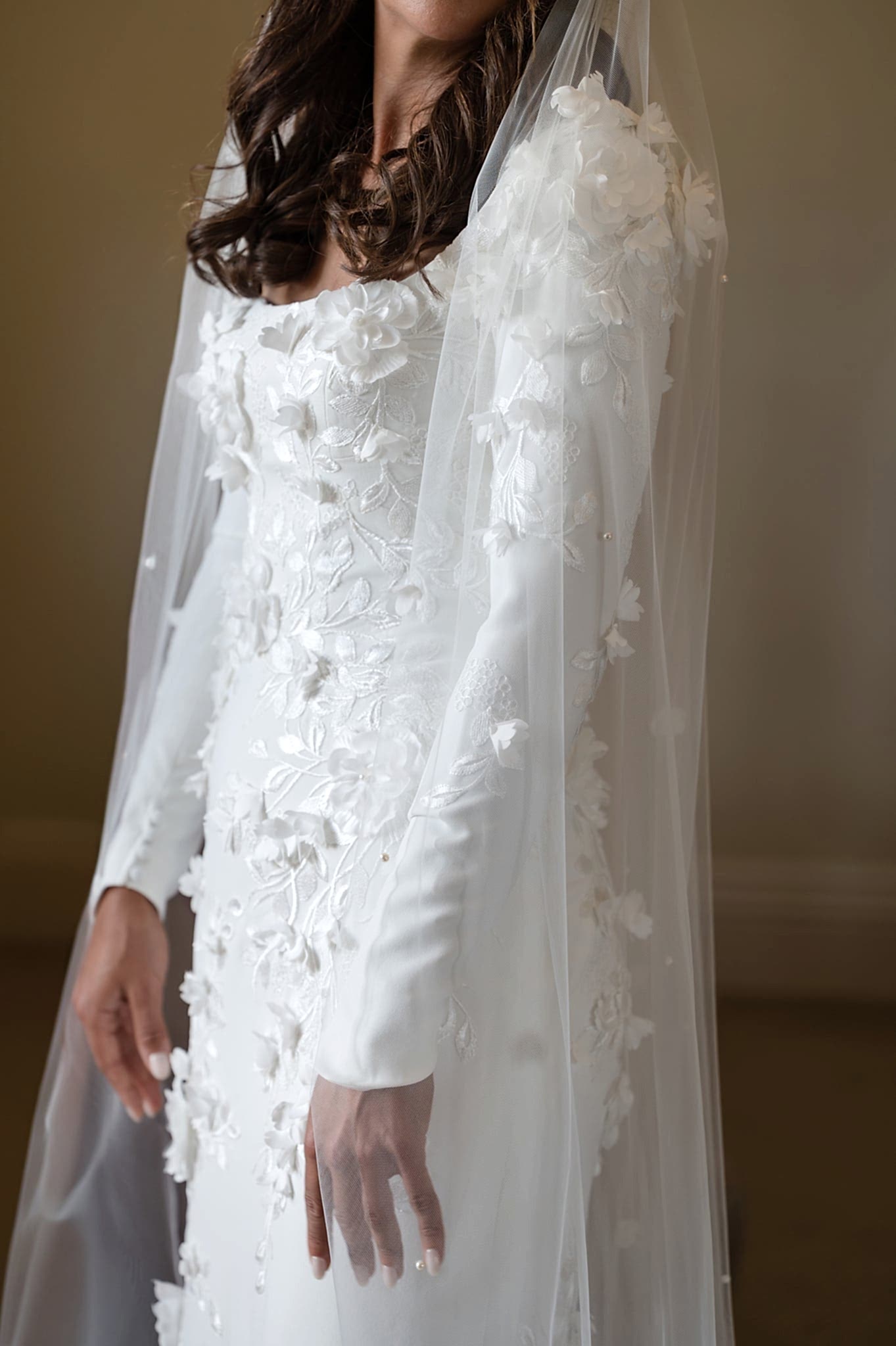 A close up section of floral applique on a Kelly Faetanini wedding dress