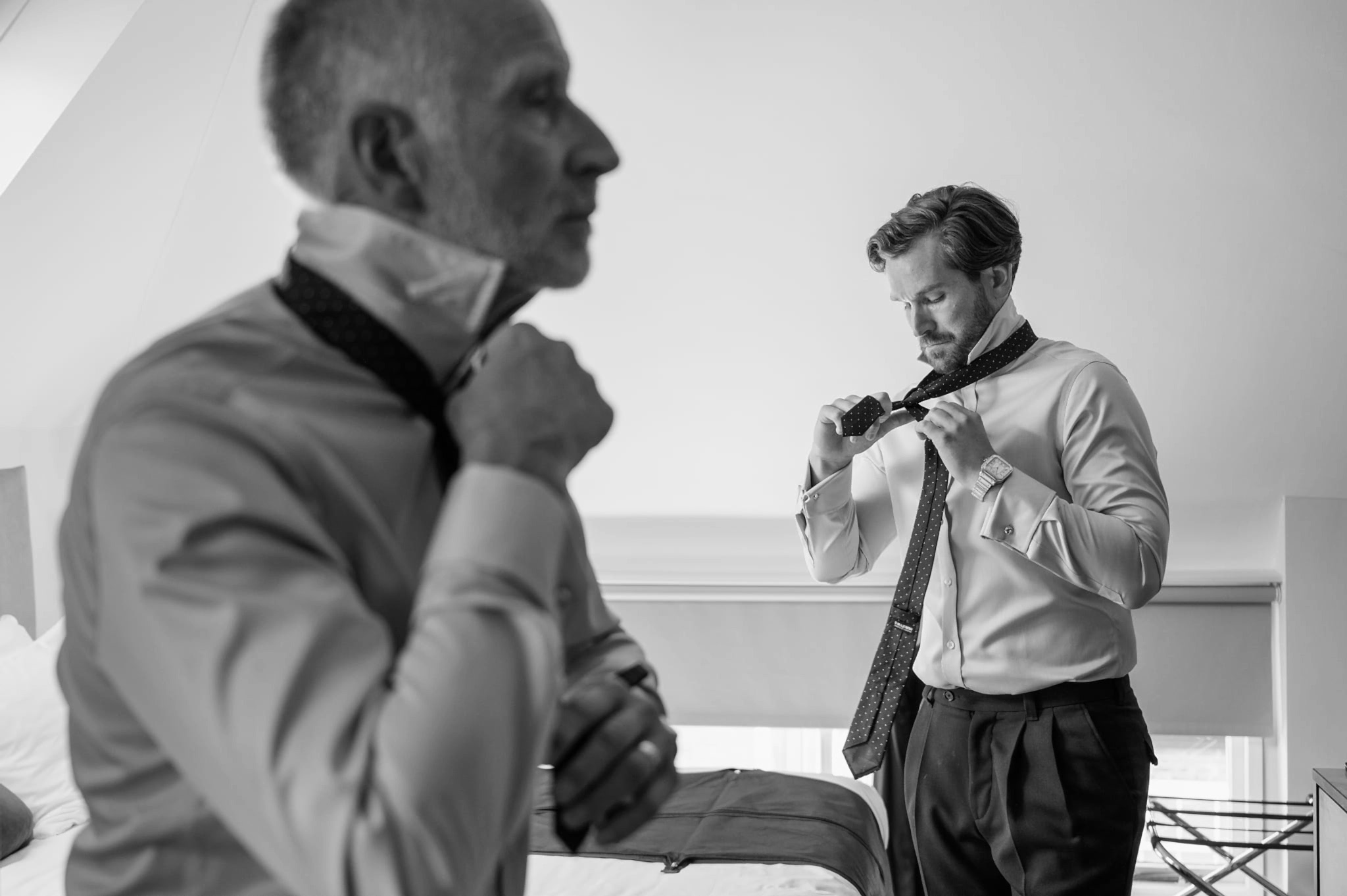 A groom and his dad putting on their ties