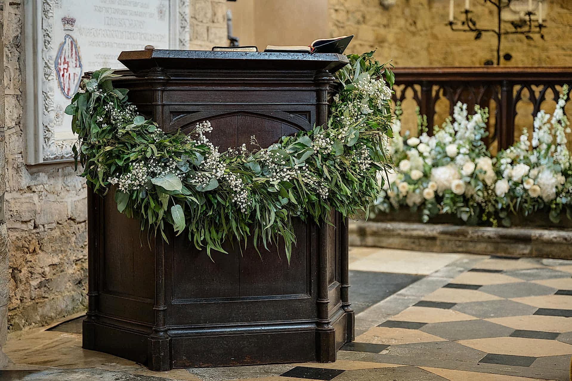 A draped foliage wreath on the pulpit at Fawsley church