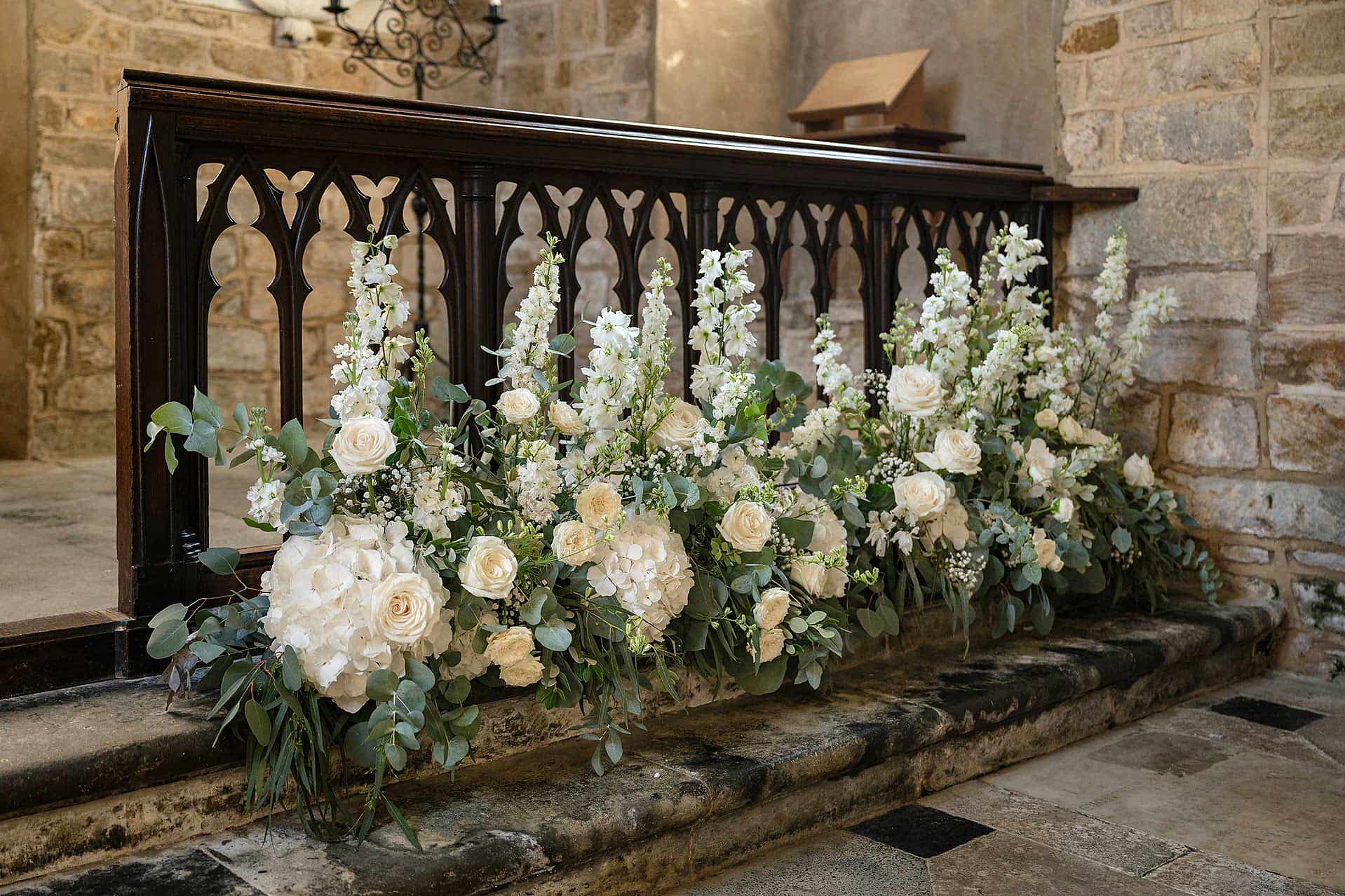 Fresh white flowers on the altar rail at Fawsley church