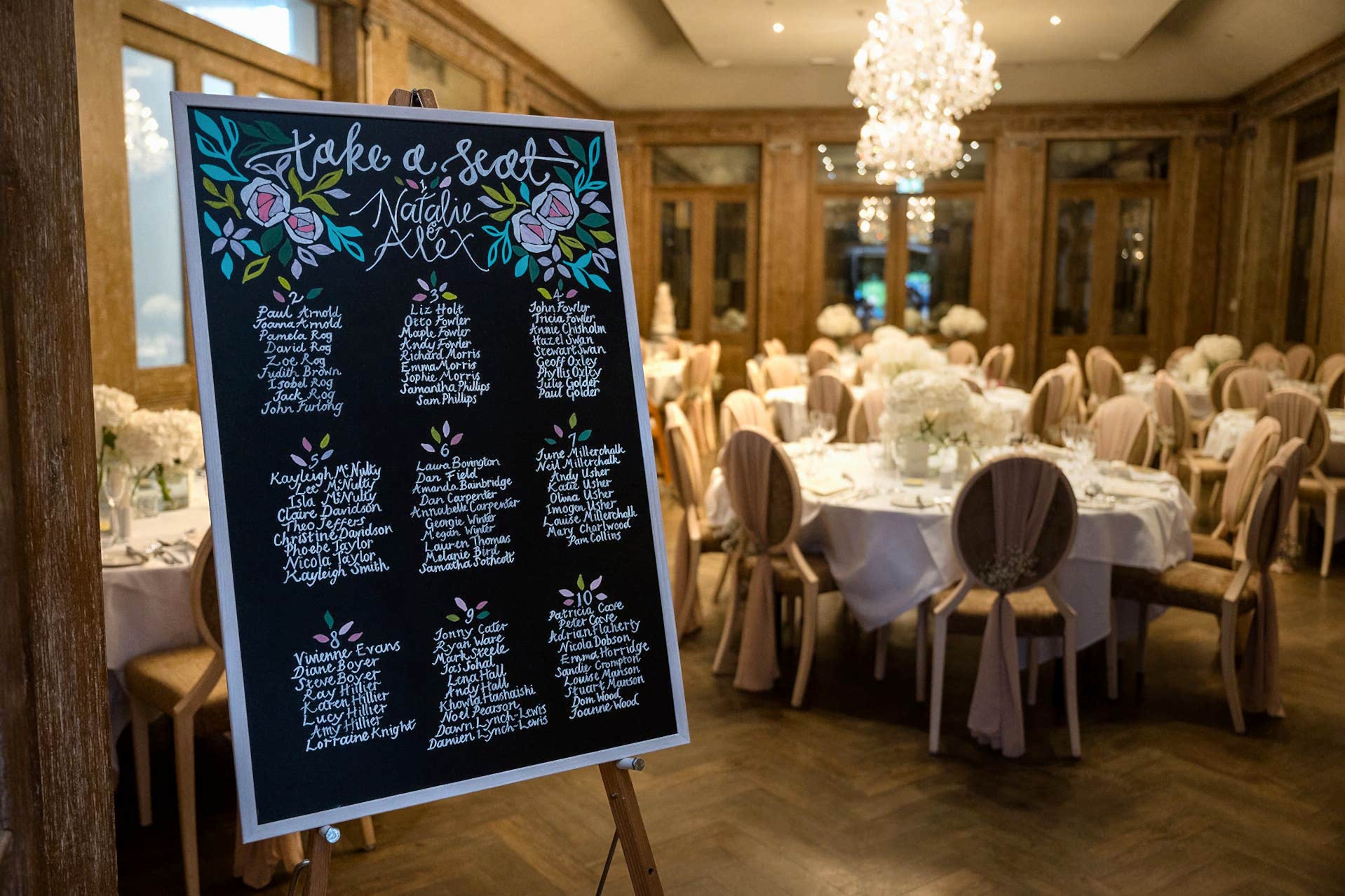A chalkboard table plan at the entrance to the dining room in Knightley Court at Fawsley Hall