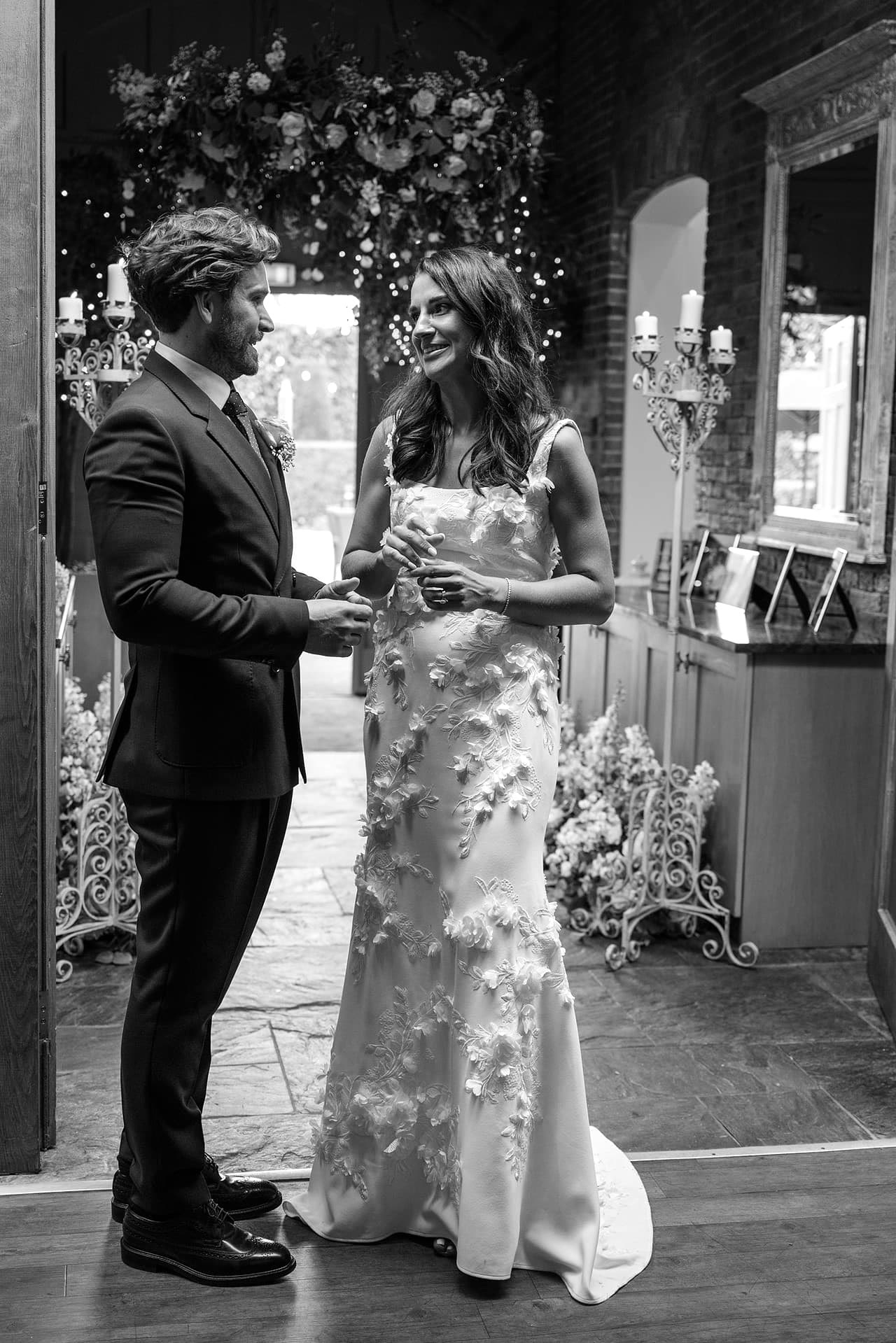 The bride and groom chatting alone while they wait to be announced into the room for their wedding breakfast