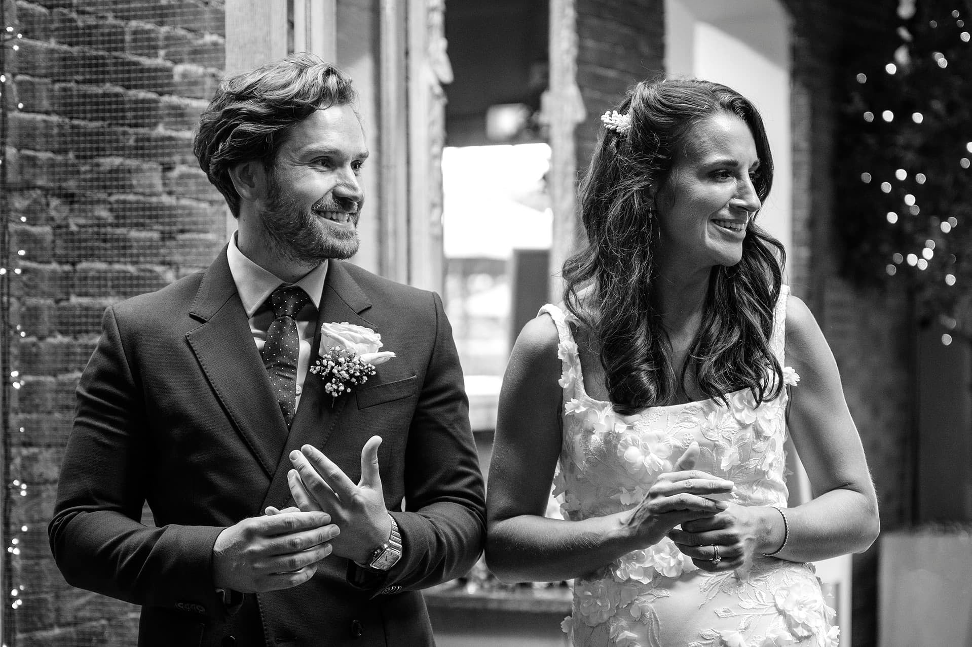 The bride and groom chatting alone while they wait to be announced into the room for their wedding breakfast