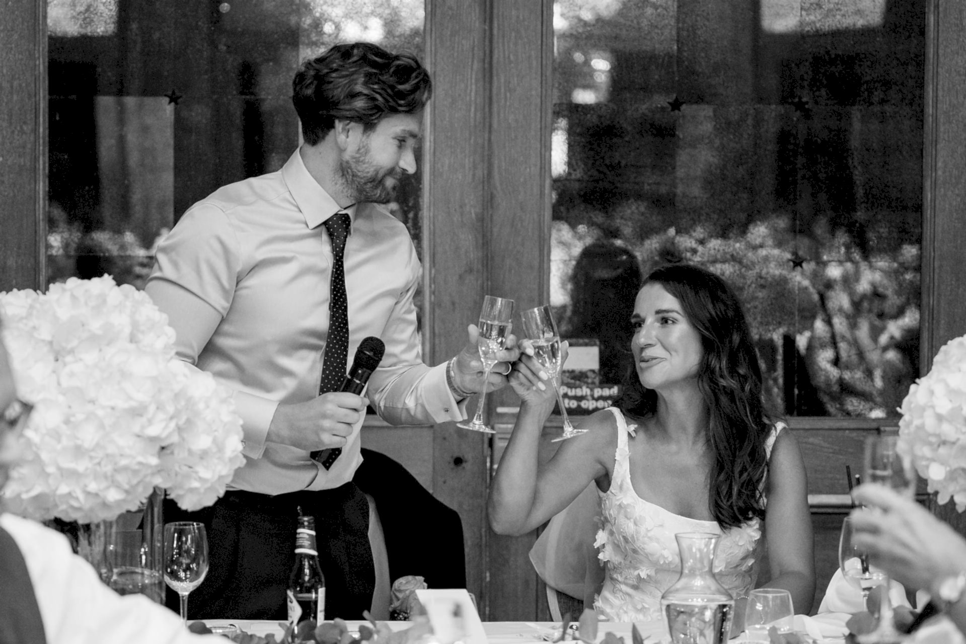 The bride and groom toasting each other after the groom's speech