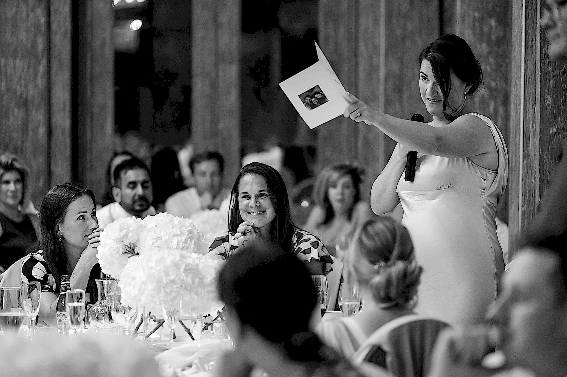 A bridesmaid pointing to the bride during her speech