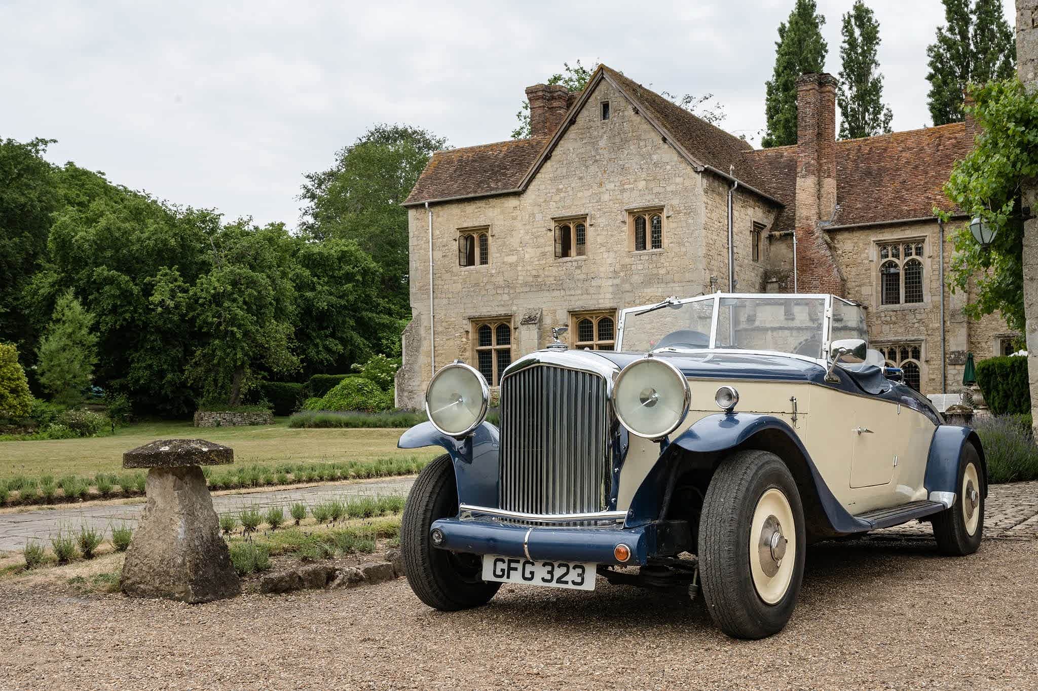 A vintage wedding car parked outside Notley Abbey