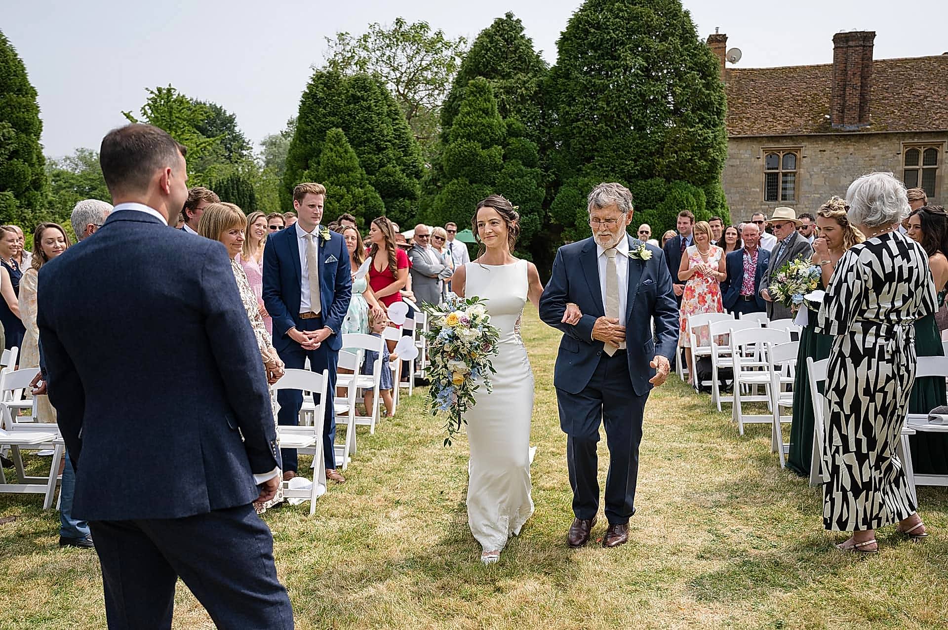 The bride and her dad walking down the aisle at Notley Abbey