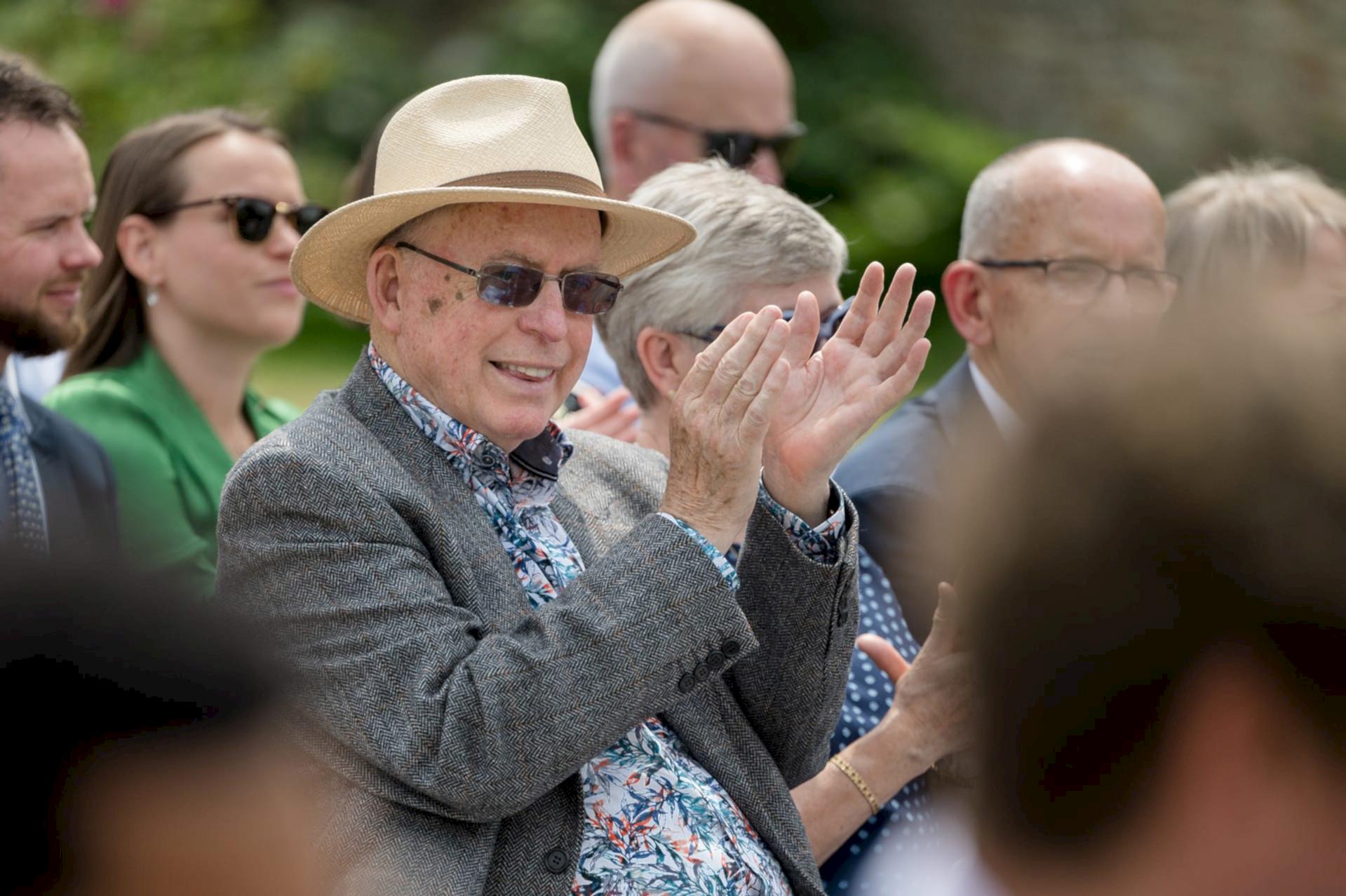 A wedding guests clapping after a wedding ceremony reading