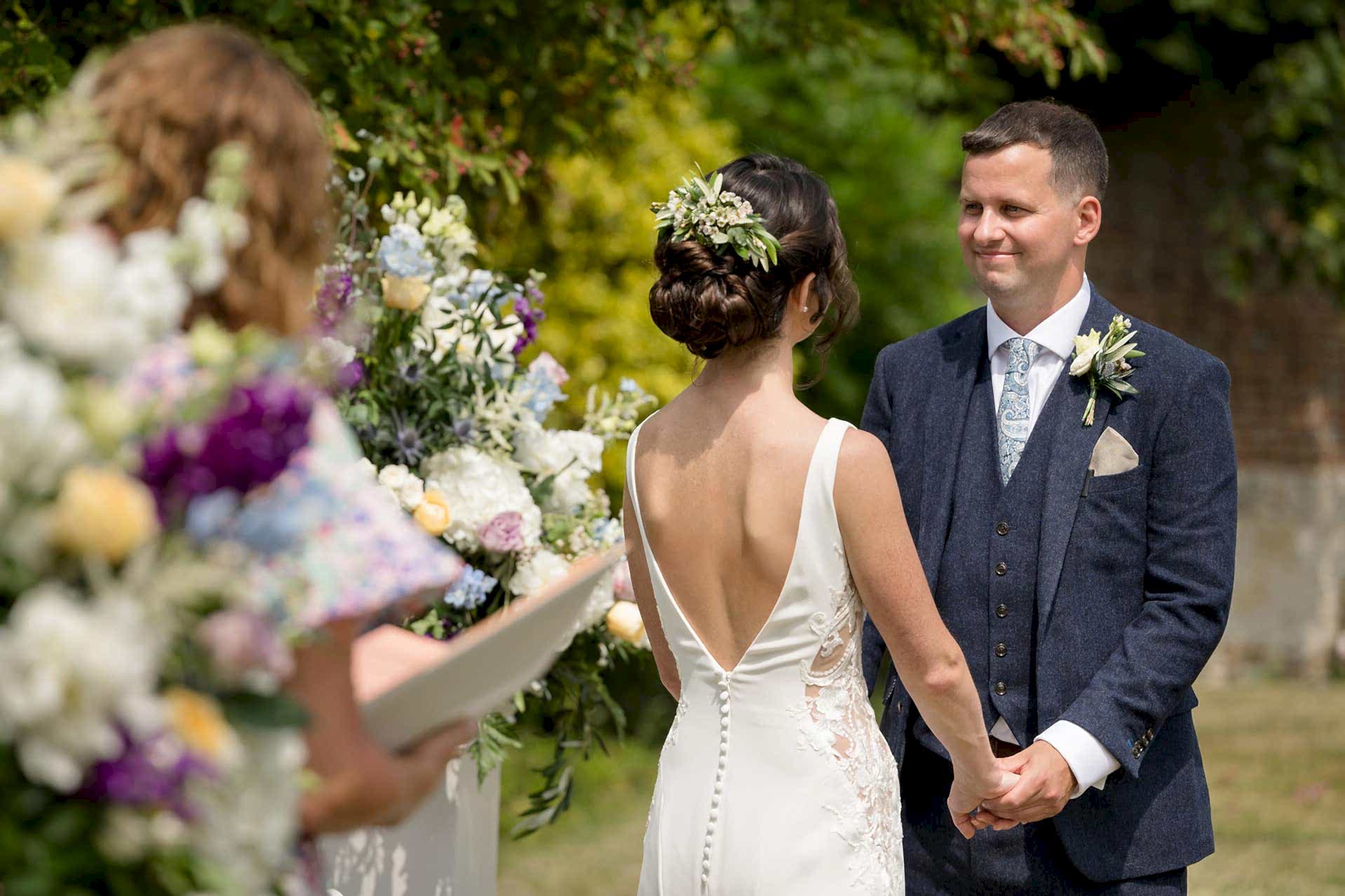 Groom looking lovingly at the bride as they say their wedding vows