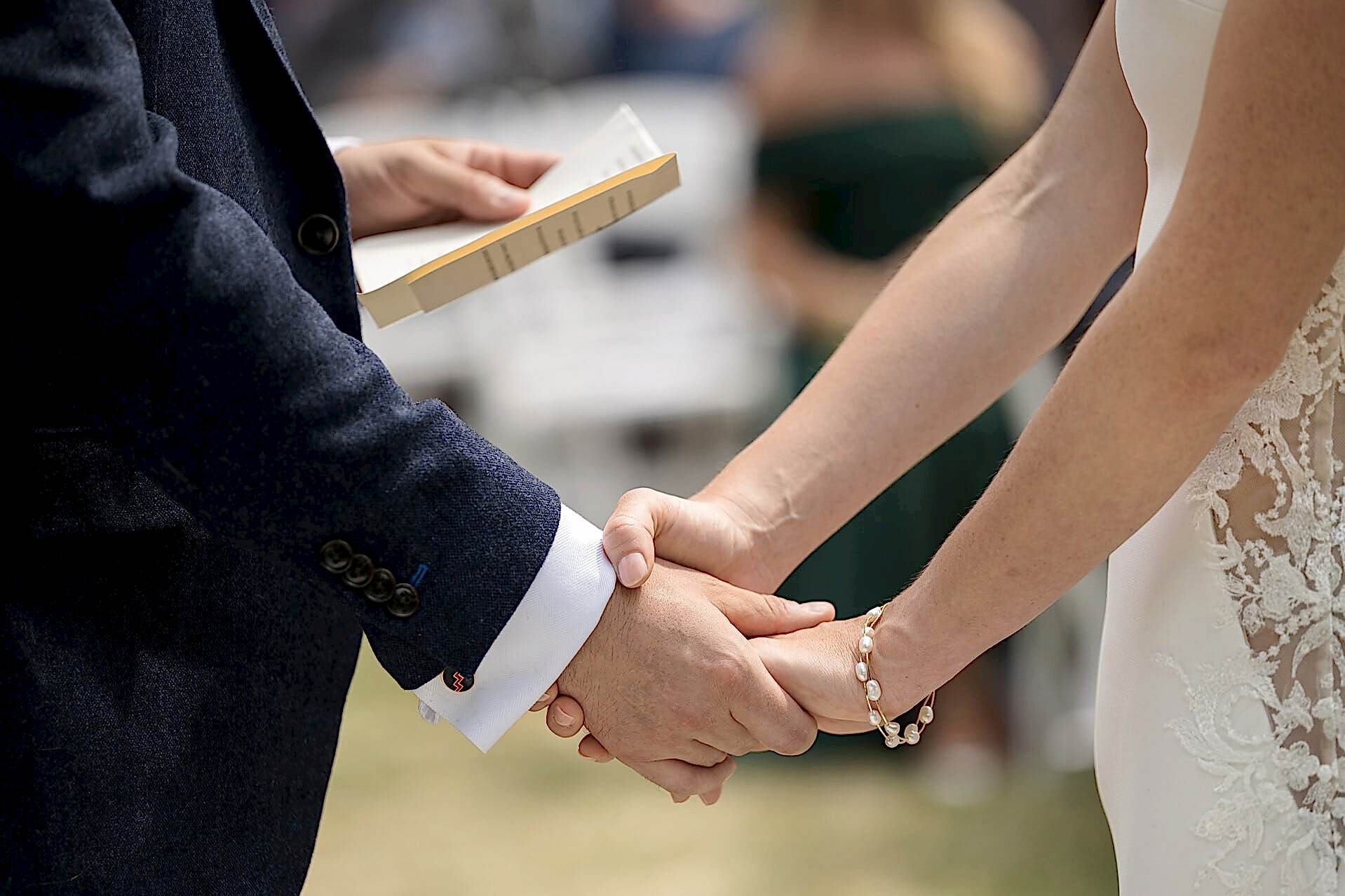 Close up of the bride and groom's hands as they make their wedding vows