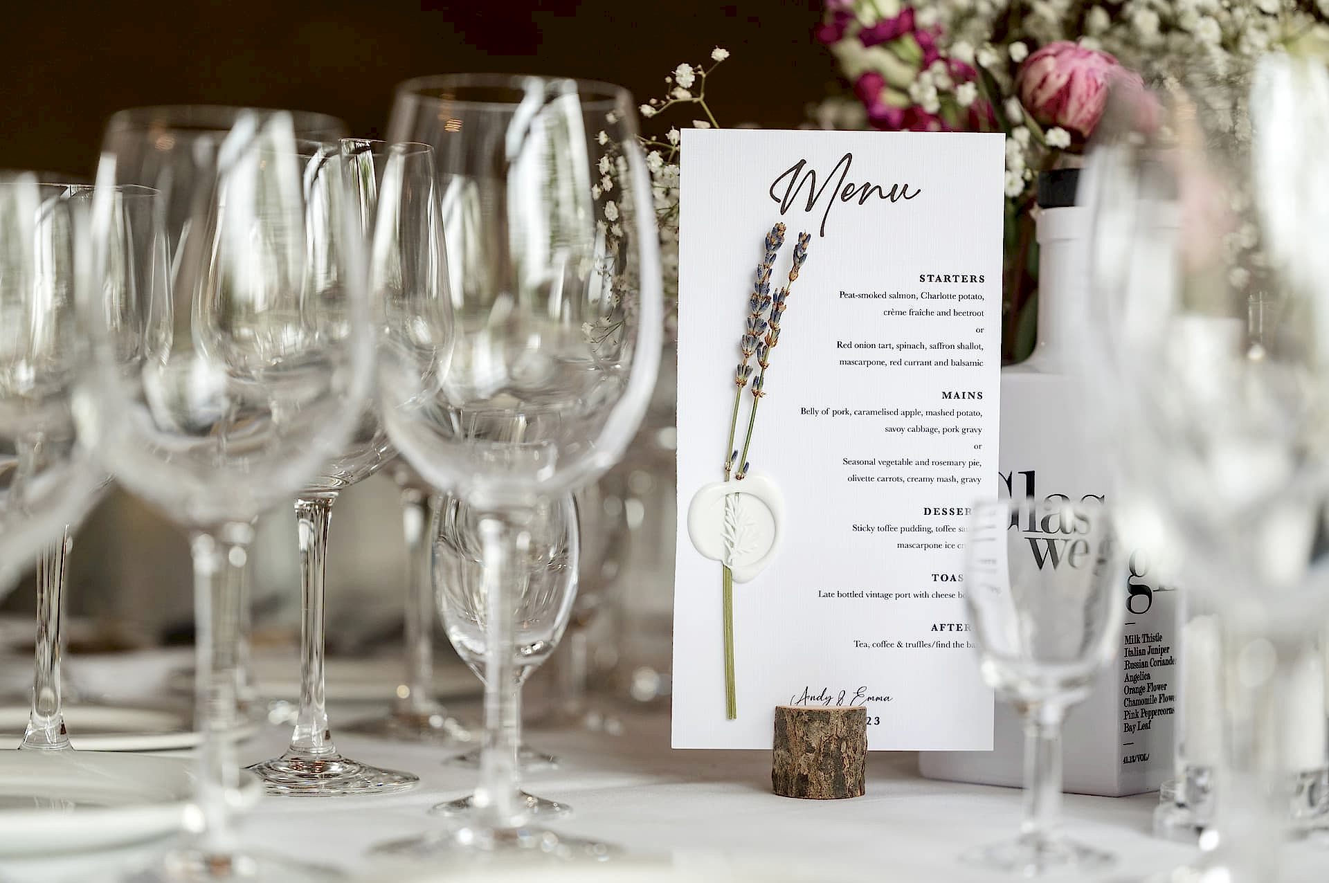 A wedding breakfast menu decorated with a sprig of lavender held in place with a white wax seal