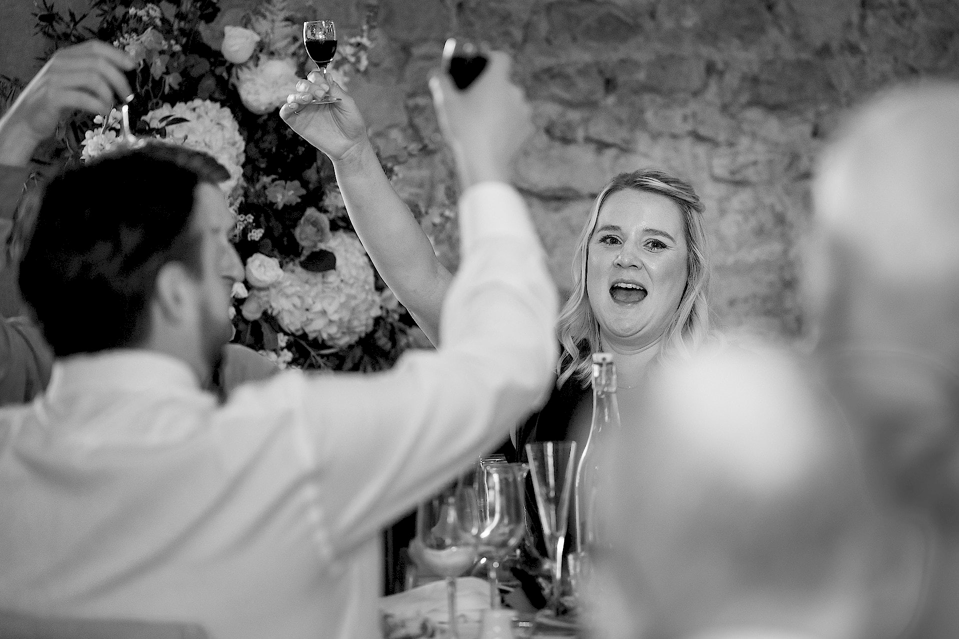 Wedding guests raising glasses of port in a toast