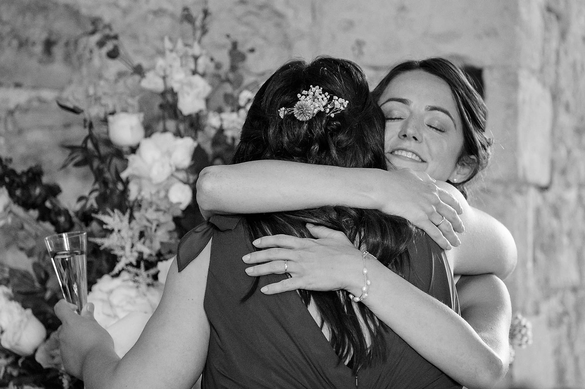 Bride hugging her bridesmaid to thank her for her speech