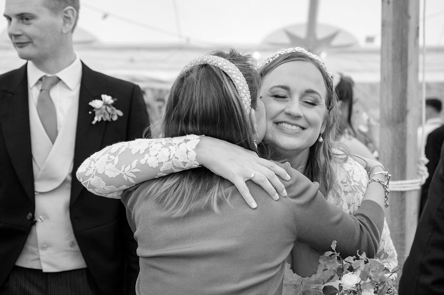 Bride hugging wedding guest