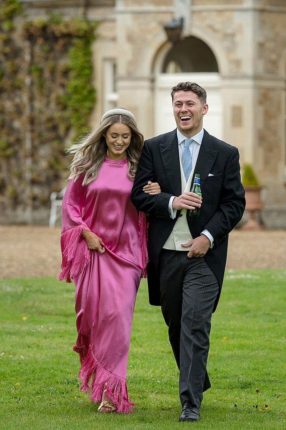 Smartly dressed couple at a wedding