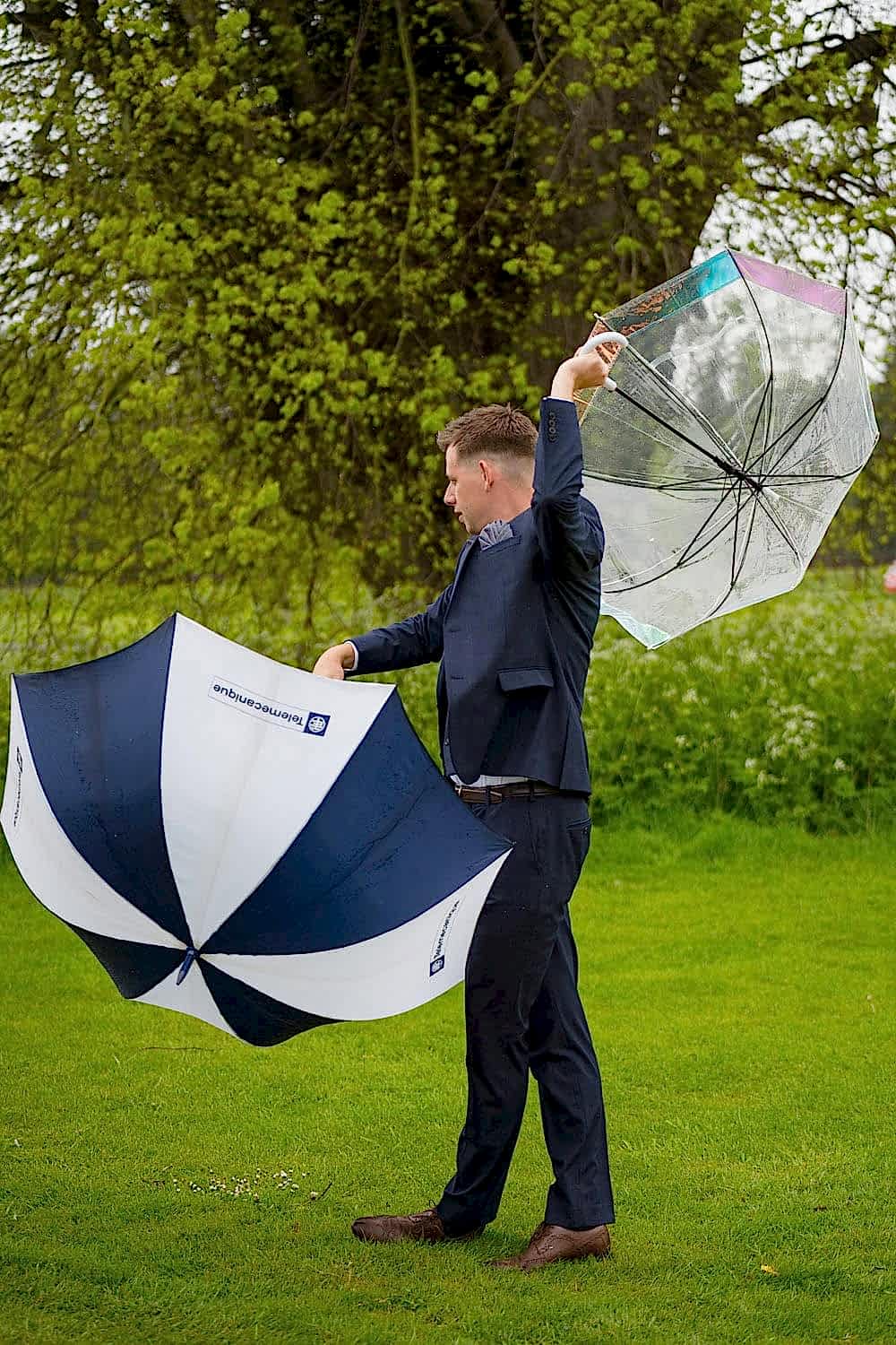 Wedding Usher dancing with large umbrellas