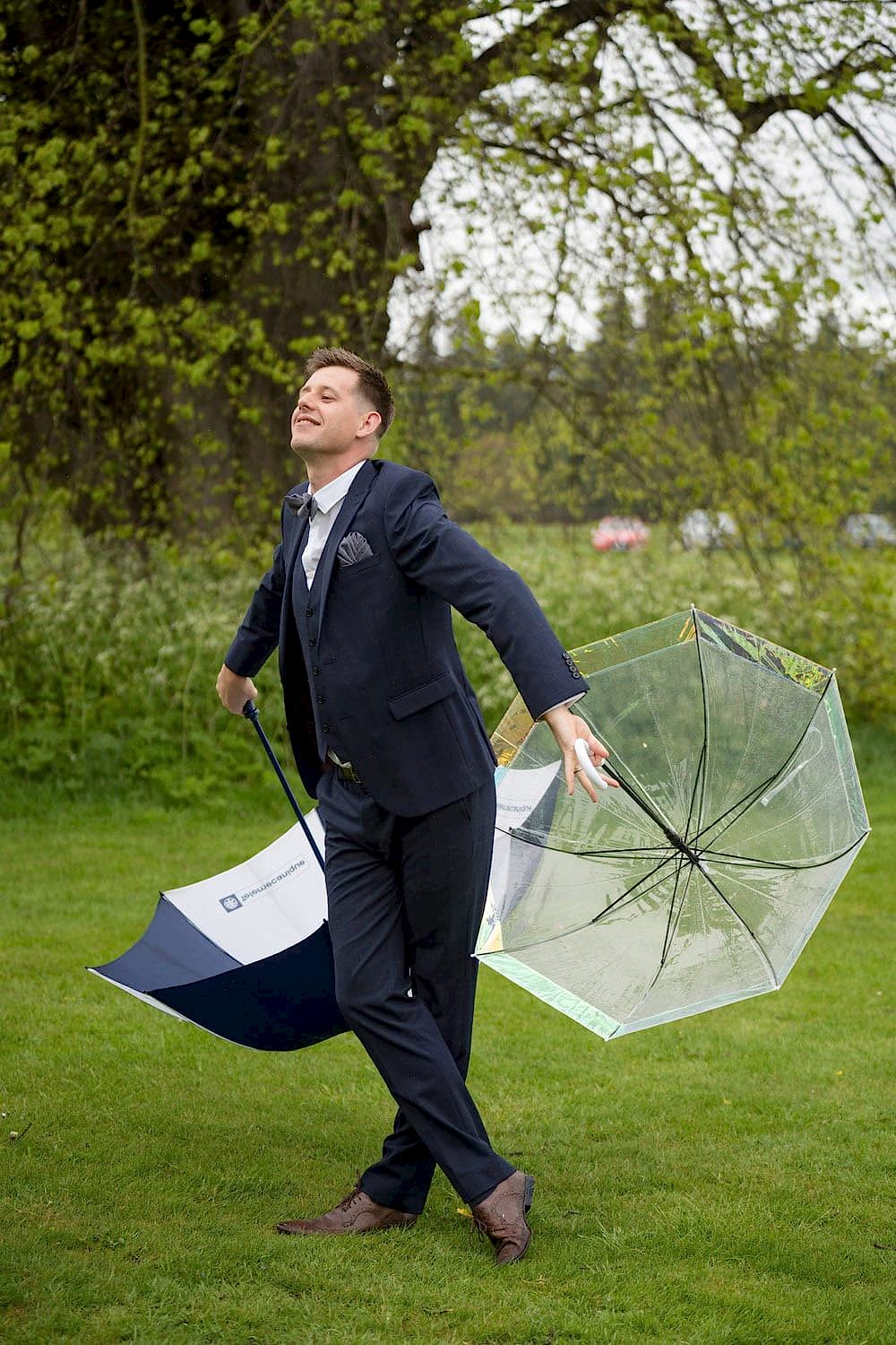 Wedding Usher dancing with large umbrellas