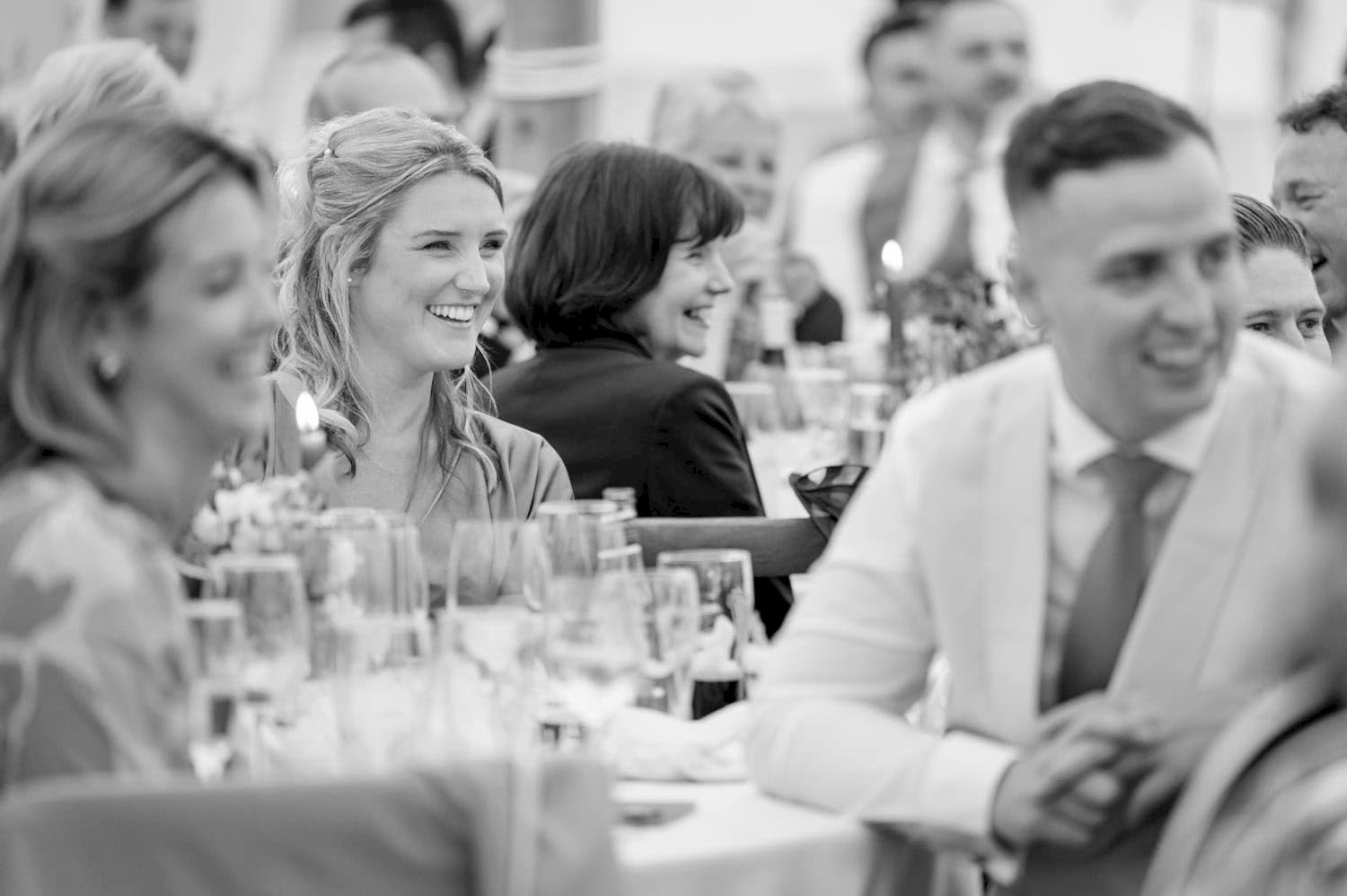 Wedding guests laughing during the speeches