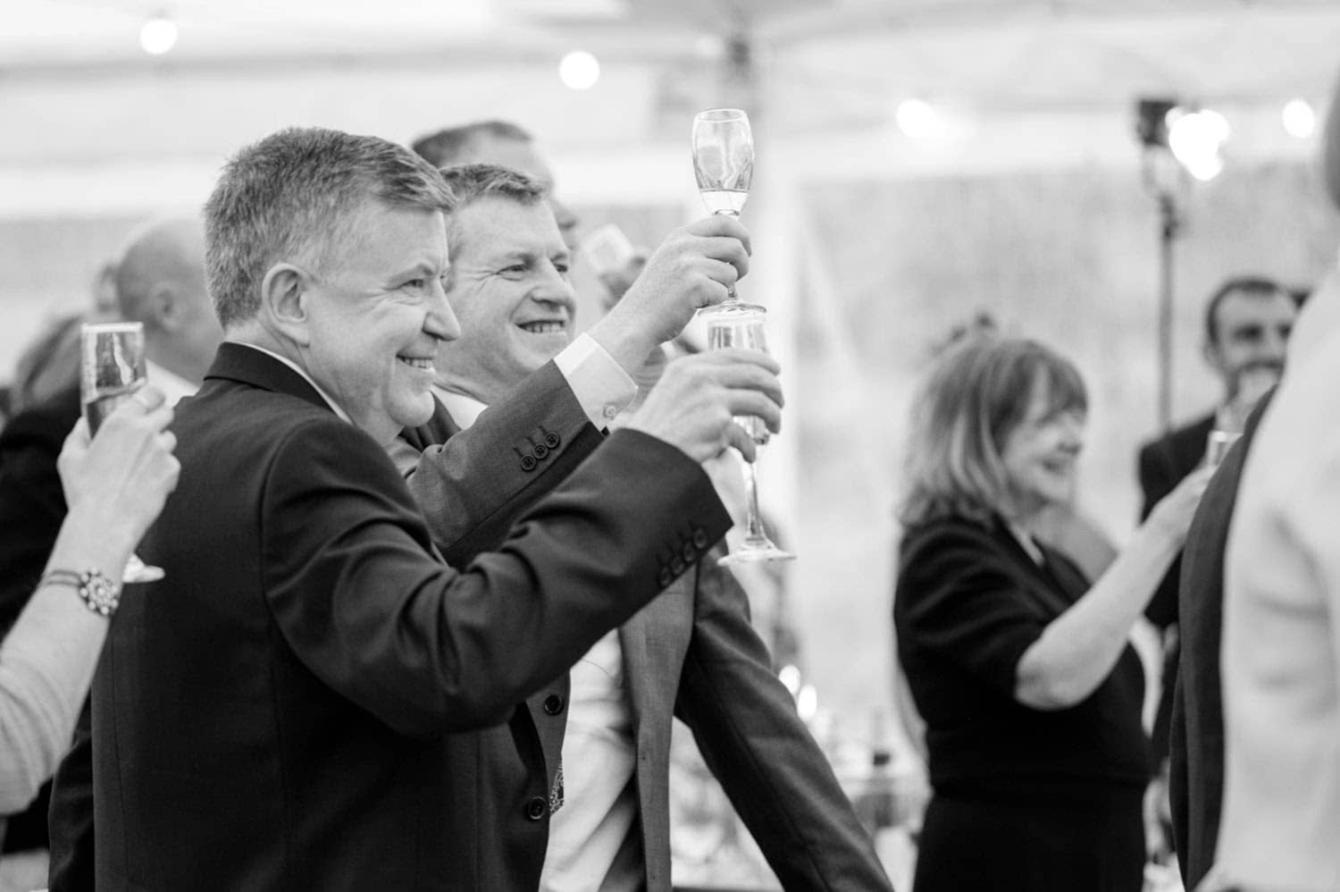 Wedding guests raising their glasses for a toast