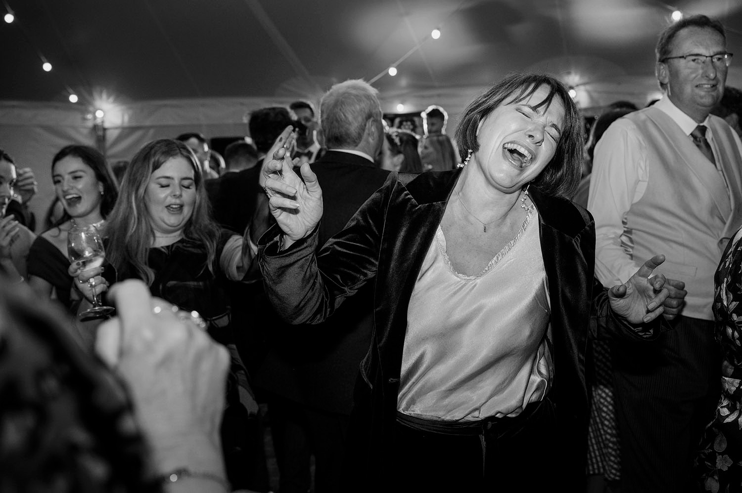 Wedding guests lost in the music and singing on the dancefloor