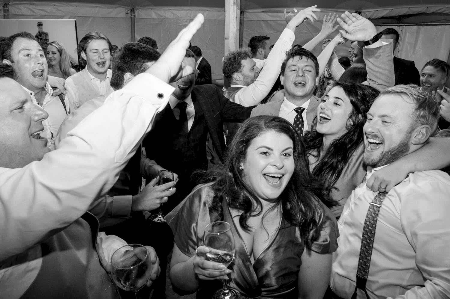 Shared joy between guests on the dancefloor at a wedding
